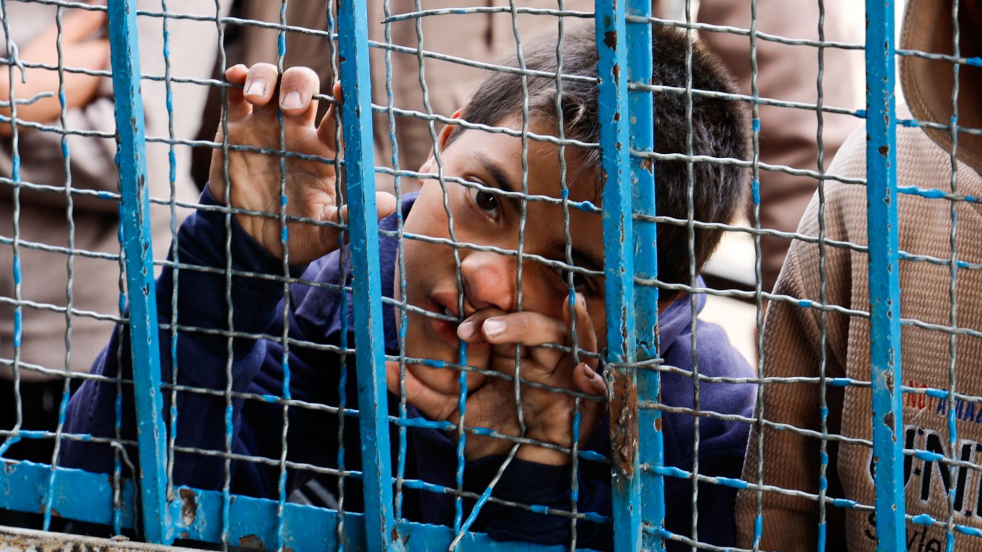 Palestinian children gather to receive bread from a bakery in Khan Younis in March. /Hatem Khaled/Reuters 