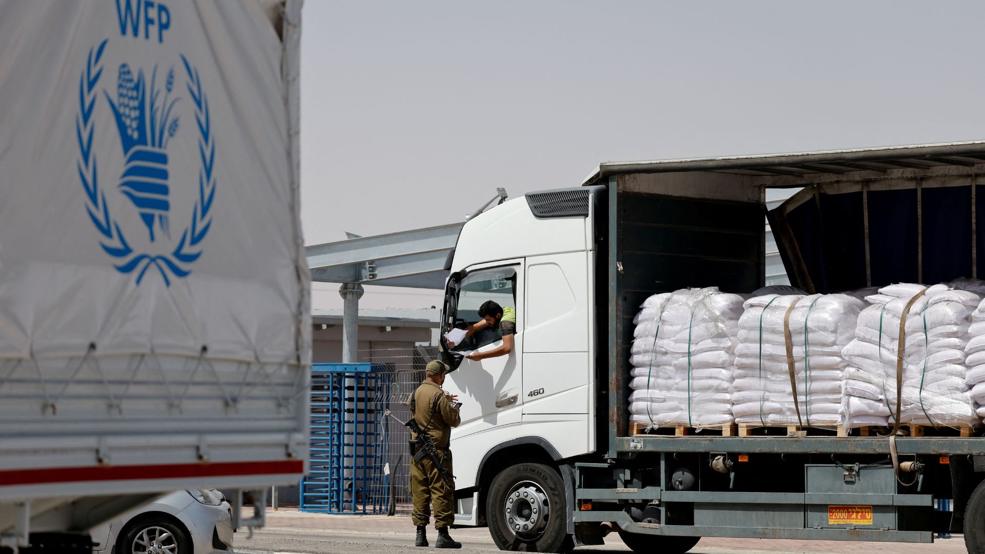 A World Food Program aid truck is checked by military at the Kerem Shalom border crossing on Monday. /Amir Cohen/Reuters